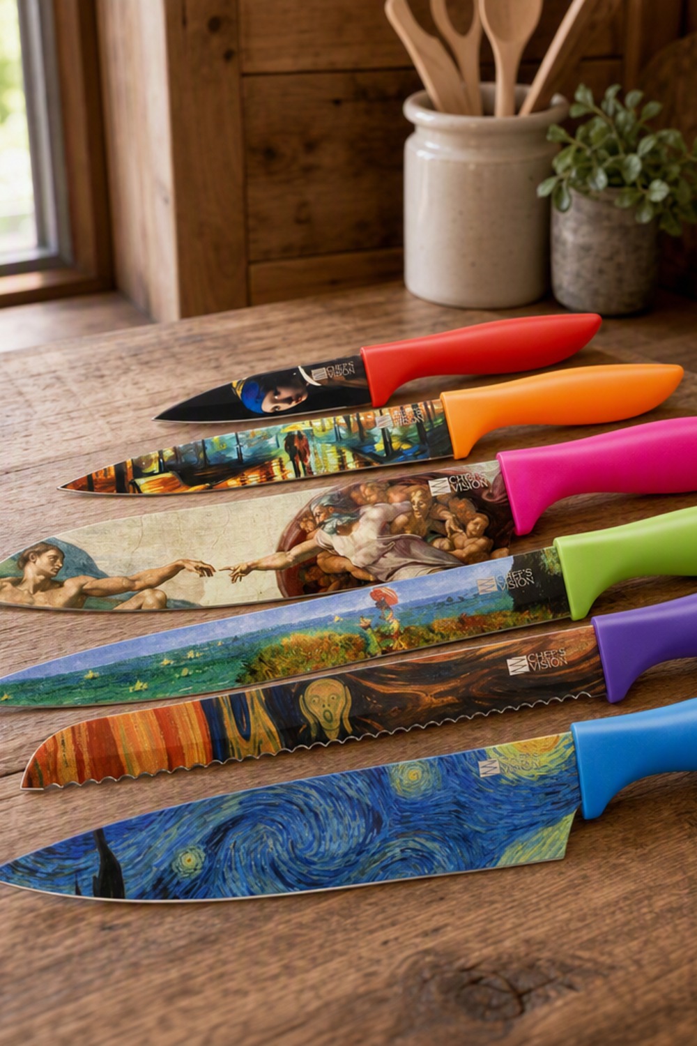 Six-piece knife set with famous paintings printed on the blades and rainbow-colored handles, fanned on a rustic cabin kitchen counter