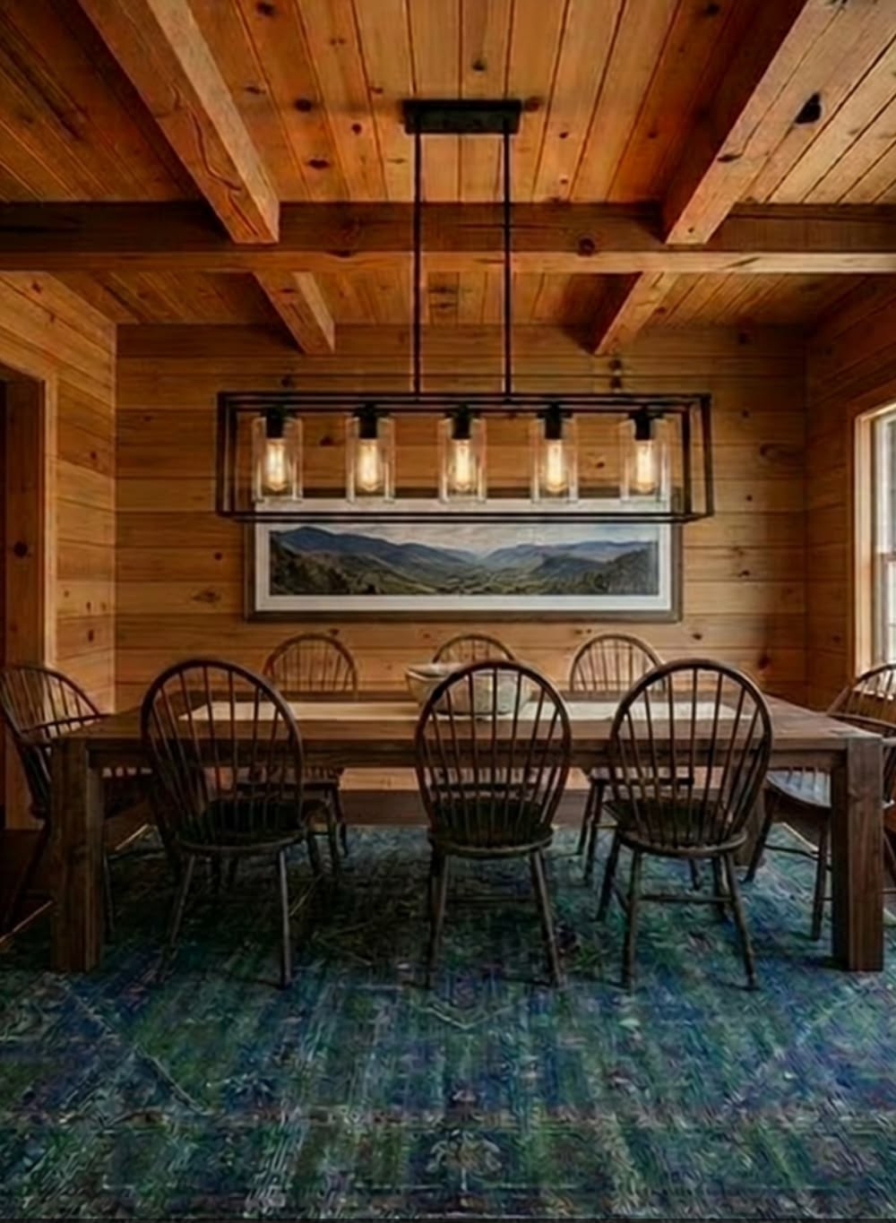 Linear rectangular chandelier with glass shades over a cabin dining table