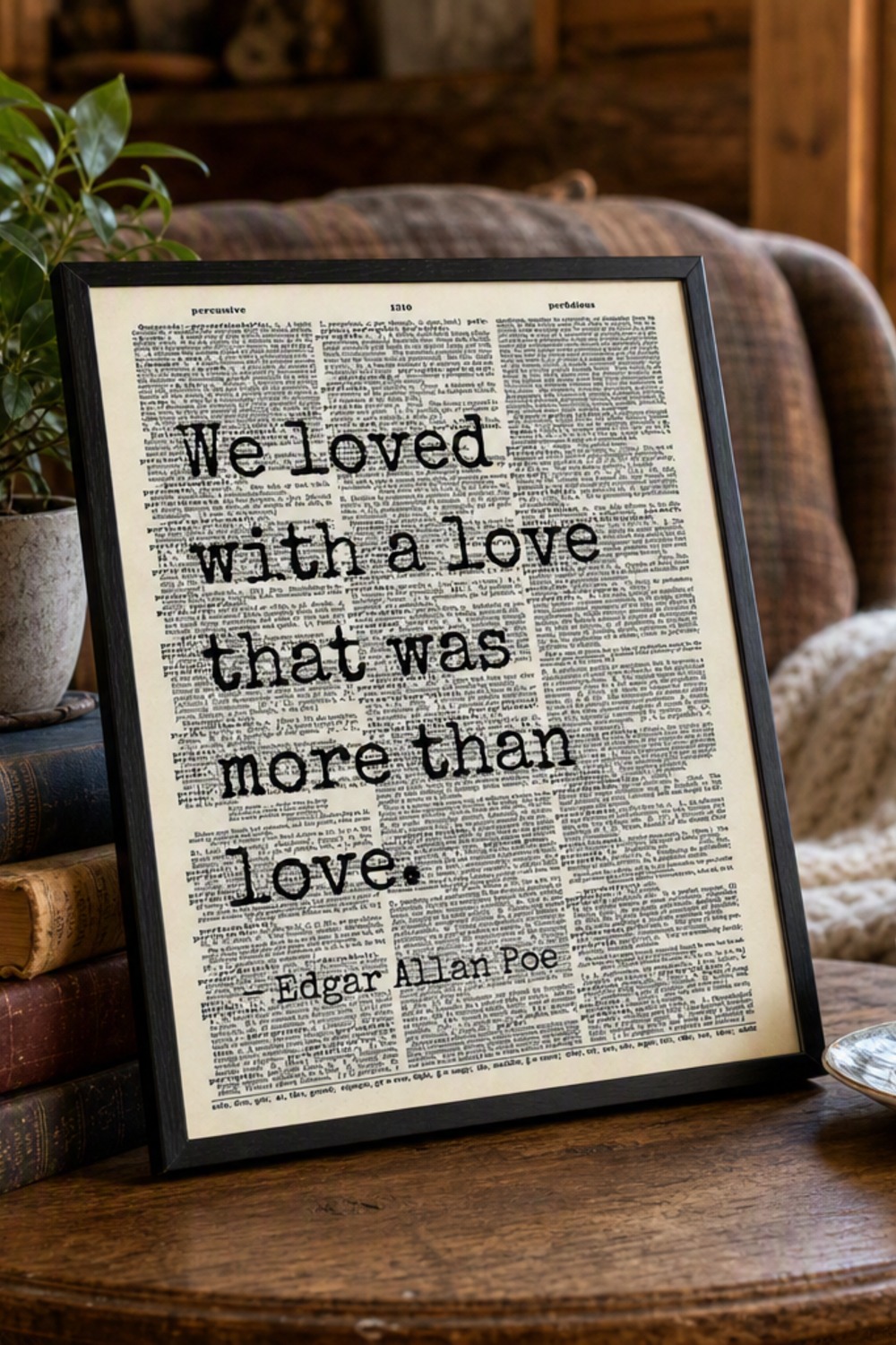 Framed Edgar Allan Poe quote dictionary page print hanging above a reading nook armchair in a cabin bedroom